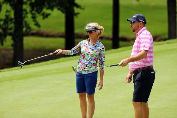 Ann Liguori and Phil Bojc discuss a shot on the 12th hole during the first round of the BMW Charity Pro-Am presented by Synnex Corporation at the...