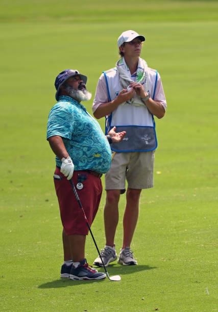 Michael Collins and his caddie stand in the fairway on the 12th hole during the first round of the BMW Charity Pro-Am presented by Synnex Corporation...