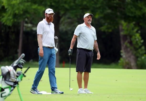 Evan Harmeling and David Wells stand in the fairway on the 12th hole during the first round of the BMW Charity Pro-Am presented by Synnex Corporation...