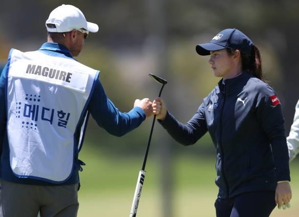 Leona Maguire of Ireland is congratulated by her caddy after finishing her round on the 9th hole during the first round of the LPGA Mediheal...