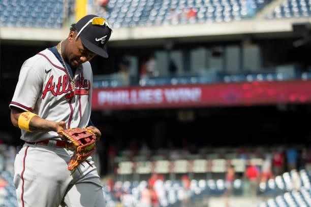 Ronald Acuna Jr. #13 of the Atlanta Braves walks off the field after losing to the Philadelphia Phillies in the bottom of the tenth inning at...