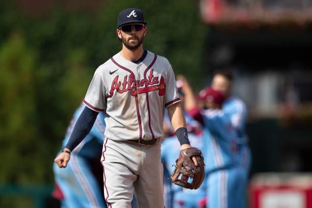 Dansby Swanson of the Atlanta Braves walks off the field after losing to the Philadelphia Phillies in the bottom of the tenth inning at Citizens Bank...