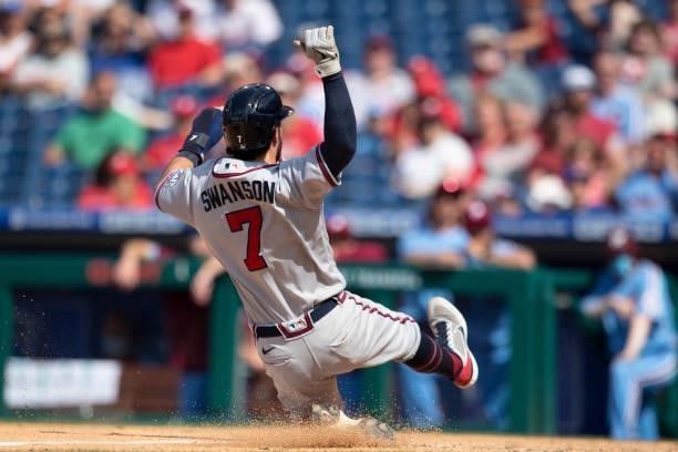 Dansby Swanson of the Atlanta Braves slides home safely to score a run in the top of the tenth inning against the Philadelphia Phillies at Citizens...