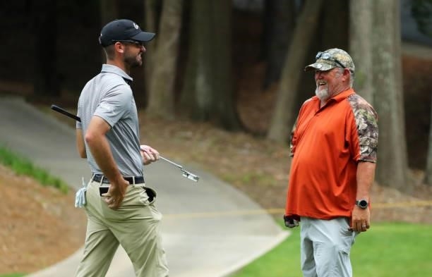 Brandon Crick shares a laugh with Larry the Cable Guy on the fourth hole during the first round of the BMW Charity Pro-Am presented by Synnex...