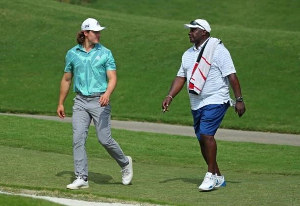 Charlie Saxon and Sterling Sharpe walk to their balls on the fourth hole during the first round of the BMW Charity Pro-Am presented by Synnex...