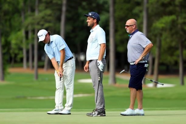 Michael Miller, Ryan McCormack and Dan Minerva stand on the green on the third hole during the first round of the BMW Charity Pro-Am presented by...