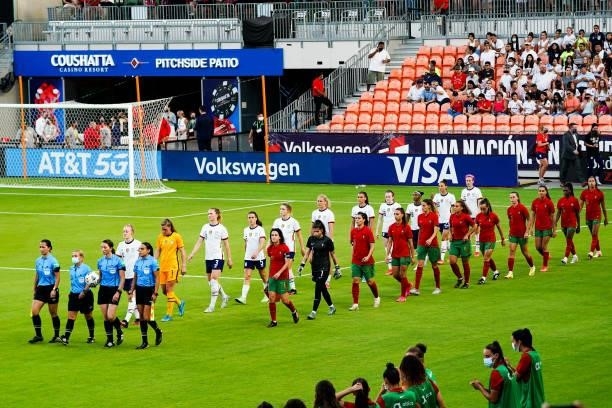 Match officials and players from the United States and Portugal women's national teams walk out to the field prior to the 2021 WNT Summer Series...
