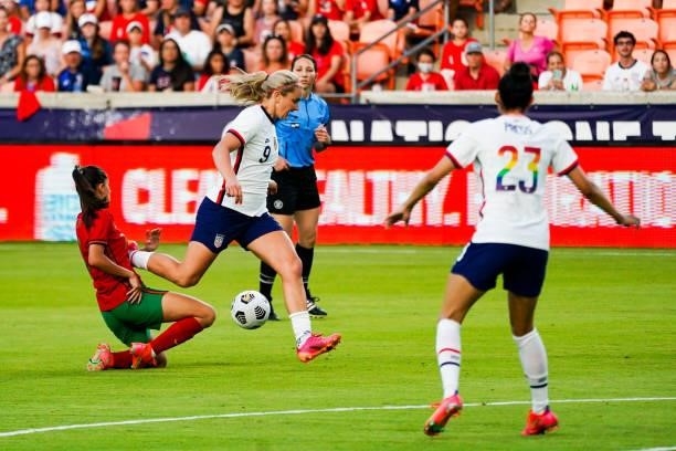 Lindsey Horan of the United States gets tripped up by Francisca Nazareth of Portugal during the 2021 WNT Summer Series friendly at BBVA Stadium on...