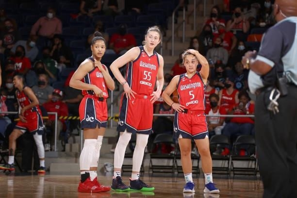 Stella Johnson, Theresa Plaisance and Leilani Mitchell of the Washington Mystics look on during the game against the Los Angeles Sparks on June 10,...