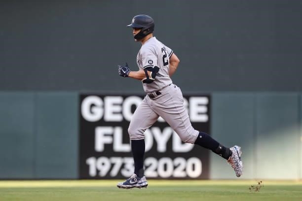 Giancarlo Stanton of the New York Yankees rounds the bases after hitting a three-run home run against the Minnesota Twins in the first inning of the...