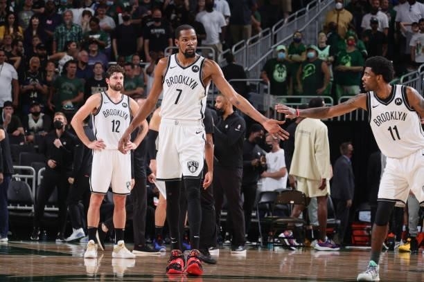 Kevin Durant of the Brooklyn Nets high fives Kyrie Irving of the Brooklyn Nets during Round 2, Game 3 of the 2021 NBA Playoffs on June 10, 2021 at...