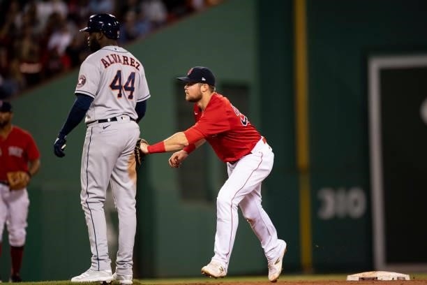 Christian Arroyo of the Boston Red Sox tags out Yordan Alvarez of theHouston Astros during the seventh inning of a game on June 10, 2021 at Fenway...