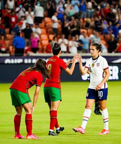 Carli Lloyd of the United States high fives Melissa Gomes of Portugal at the conclusion of the 2021 WNT Summer Series friendly at BBVA Stadium on...