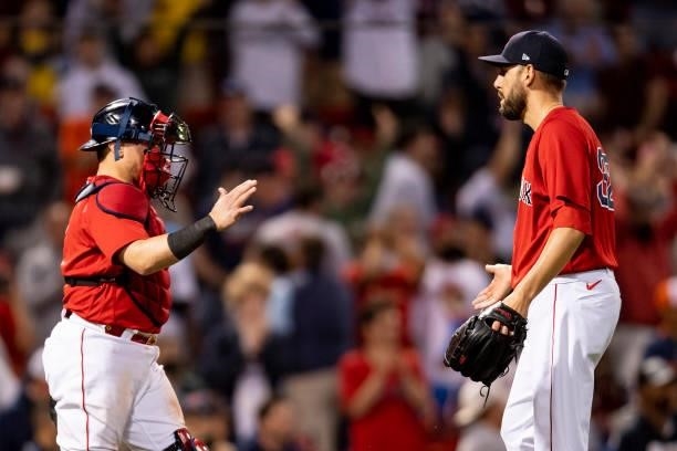 Christian Vazquez and Matt Barnes of the Boston Red Sox celebrate a victory against the Houston Astros on June 10, 2021 at Fenway Park in Boston,...