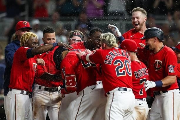 Nelson Cruz of the Minnesota Twins celebrates with teammates after hitting a two-run walk off home run against the New York Yankees in the ninth...