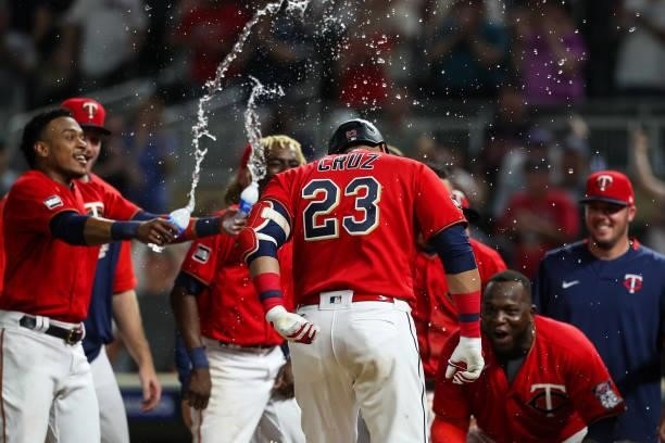 Nelson Cruz is sprayed with water by Jorge Polanco of the Minnesota Twins after hitting a two-run walk off home run against the New York Yankees in...