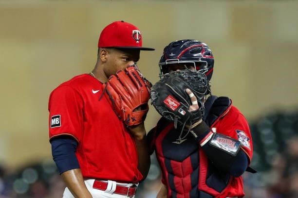 Jorge Alcala talks to Ben Rortvedt of the Minnesota Twins before pitching to the New York Yankees in the seventh inning of the game at Target Field...