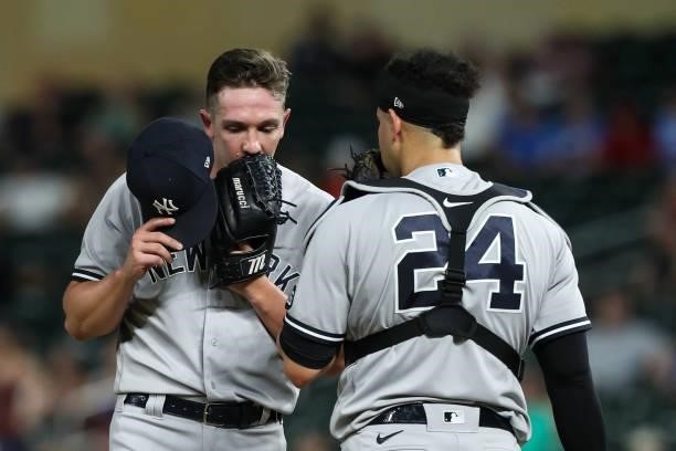 Chad Green talks to Gary Sanchez of the New York Yankees before pitching to the Minnesota Twins in the seventh inning of the game at Target Field on...