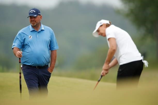 Annika Sorenstam of Sweden is watched by Thomas Bjorn of Denmark on the 9th hole during the second round of The Scandinavian Mixed Hosted by Henrik...
