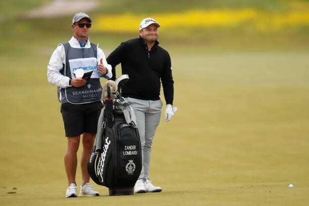 Zander Lombard of South Africa looks on with caddie on the 12th hole during the second round of The Scandinavian Mixed Hosted by Henrik and Annika at...
