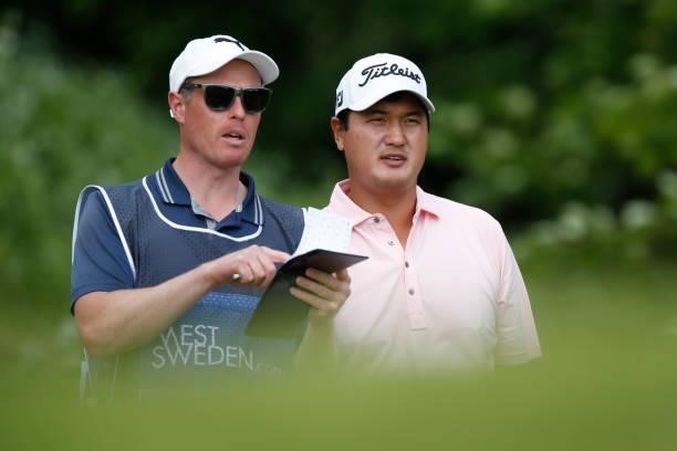 Sihwan Kim of the United States looks on with his caddie on the 13th hole during the second round of The Scandinavian Mixed Hosted by Henrik and...