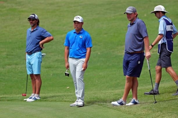 Dr. Jeff Harris, John Chin and Steven Bright stand on the green on the 12th hole during the second round of the BMW Charity Pro-Am presented by...