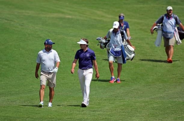 Johnson and James Nicholas walk to their balls on the ninth hole during the second round of the BMW Charity Pro-Am presented by Synnex Corporation at...