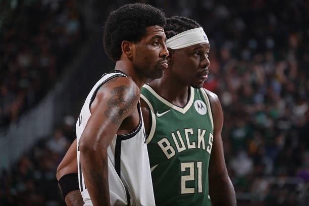 Kyrie Irving of the Brooklyn Nets and Jrue Holiday of the Milwaukee Bucks look on during Round 2, Game 3 of the 2021 NBA Playoffs on June 10, 2021 at...