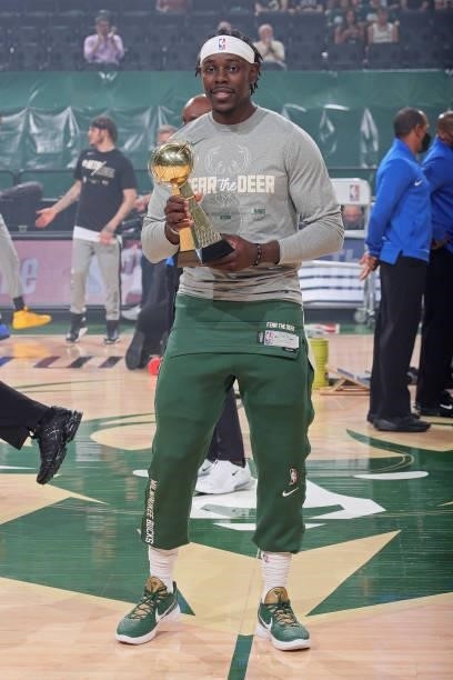 Jrue Holiday of the Milwaukee Bucks receives the Joe Dumars Trophy presented to the 2020-21 NBA Sportsmanship Award winner before the game against...