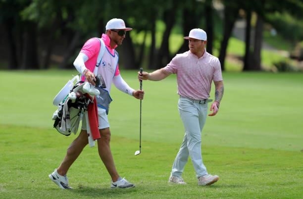 Canelo Alvarez hands his caddie a club on the 10th hole during the second round of the BMW Charity Pro-Am presented by Synnex Corporation at the...