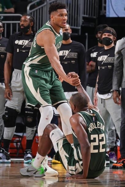 Giannis Antetokounmpo helps up Khris Middleton of the Milwaukee Bucks during Round 2, Game 3 of the 2021 NBA Playoffs on June 10, 2021 at the Fiserv...