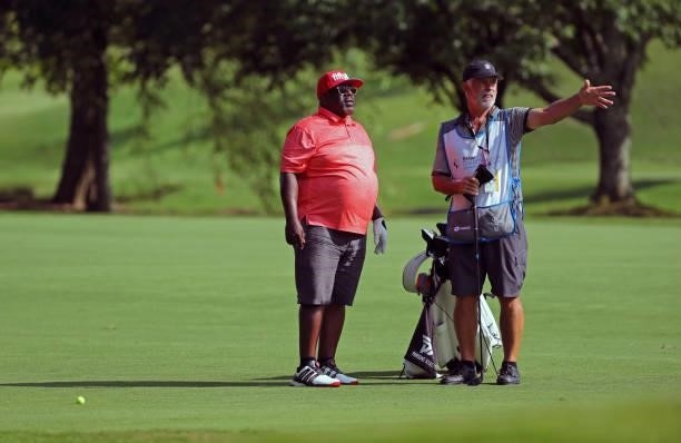 Cedric the Entertainer and his caddie discuss his shot on the fifth hole during the second round of the BMW Charity Pro-Am presented by Synnex...