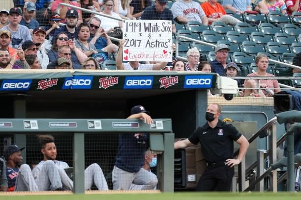 Fan holds up a sign mocking the Houston Astros in the third inning of the game against the Minnesota Twins at Target Field on June 11, 2021 in...