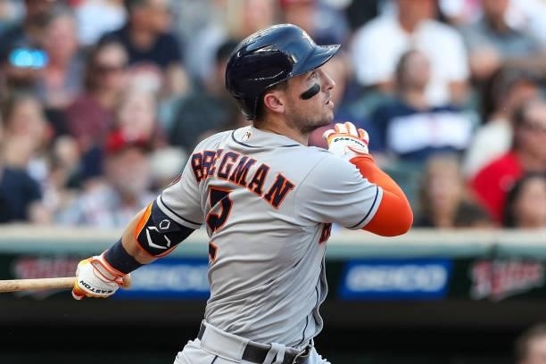Alex Bregman of the Houston Astros hits a sacrifice fly to score a run against the Minnesota Twins in the third inning of the game at Target Field on...