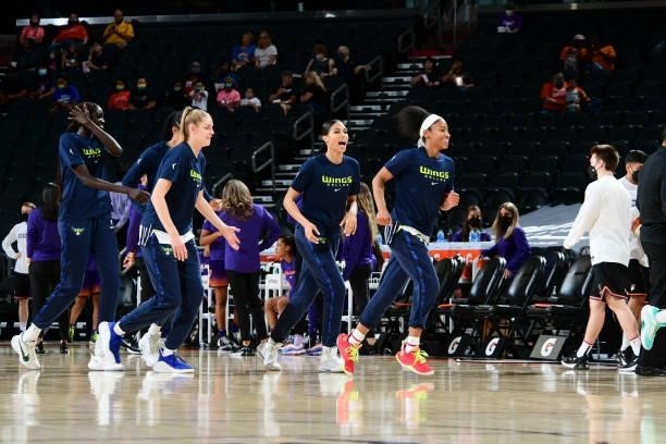 Bella Alarie of the Dallas Wings, Isabelle Harrison of the Dallas Wings and Tyasha Harris of the Dallas Wings run off of the court before the game...