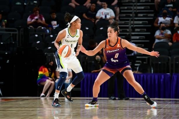 Moriah Jefferson of the Dallas Wings handles the ball during the game as Kia Nurse of the Phoenix Mercury plays defense on June 11, 2021 at Phoenix...