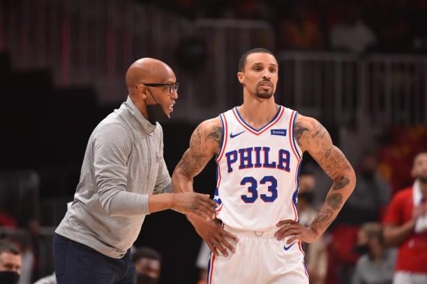 Assistant Coach Sam Cassell and George Hill of the Philadelphia 76ers talk during Round 2, Game 3 of the Eastern Conference Playoffs on June 11, 2021...