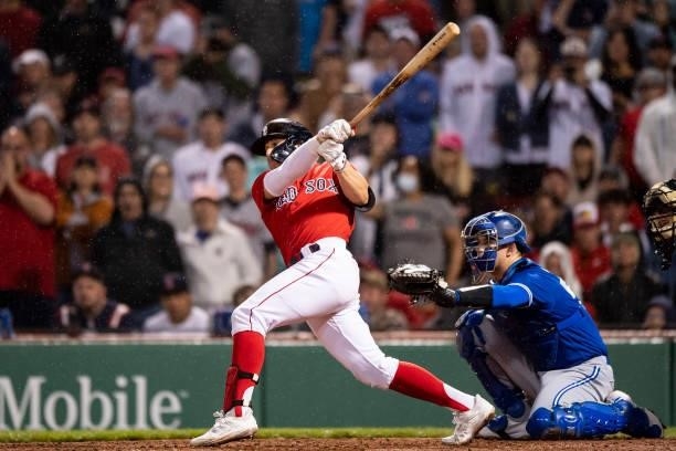 Enrique Hernandez of the Boston Red Sox hits an infield single to reach on an error during the ninth inning of a game against the Toronto Blue Jays...