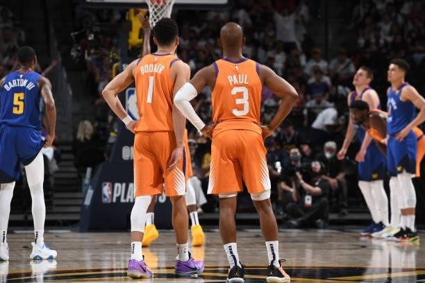 Devin Booker and Chris Paul of the Phoenix Suns look on during Round 2, Game 3 of the 2021 NBA Playoffs on June 11, 2021 at the Ball Arena in Denver,...