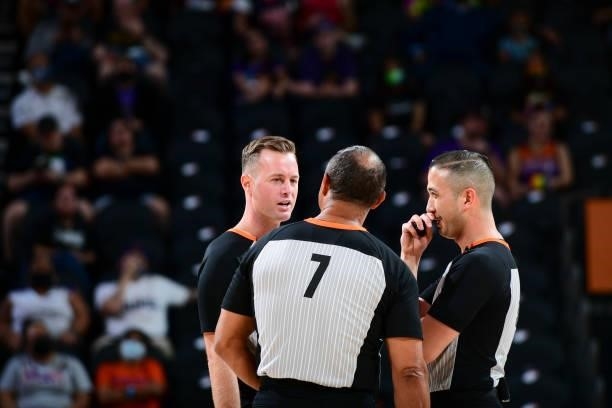 Referee Kevin Fahy, referee Billy Smith and referee Isaac Barnett talk during the game between the Dallas Wings and Phoenix Mercury on June 11, 2021...