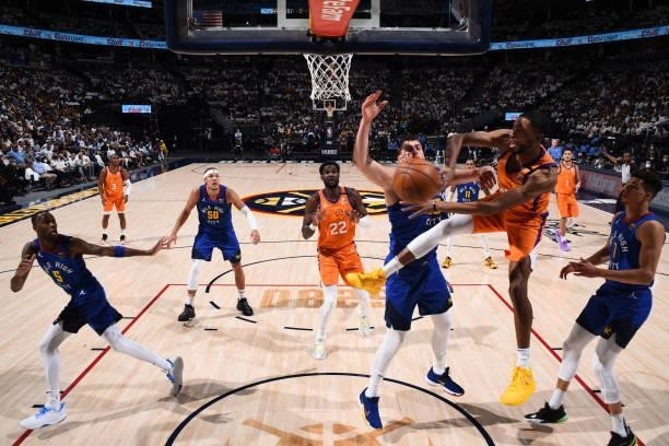 Mikal Bridges of the Phoenix Suns drives to the basket and looks to pass the ball against the Denver Nuggets during Round 2, Game 3 of the 2021 NBA...