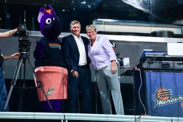 Vice President, Ann Meyers Drysdale of the Phoenix Mercury presents Former President, Rick Welts of the Phoenix Suns with a jersey during the game...