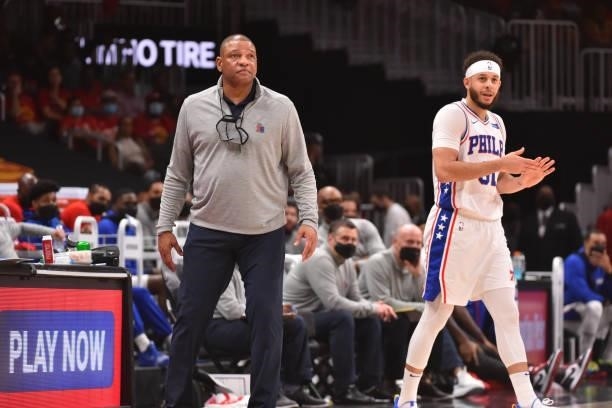 Head Coach Doc Rivers and Seth Curry of the Philadelphia 76ers smile during Round 2, Game 3 of the Eastern Conference Playoffs on June 11, 2021 at...