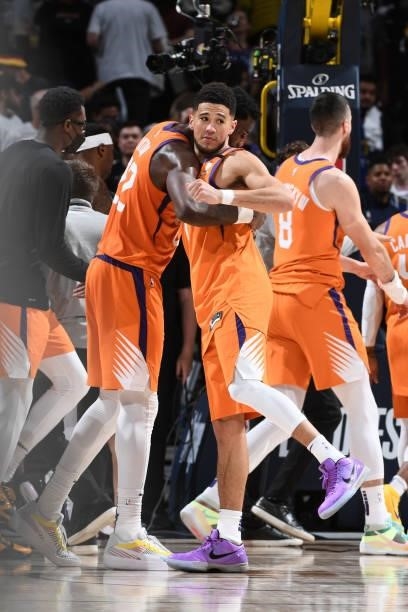 Deandre Ayton and Devin Booker of the Phoenix Suns hug after the game against the Denver Nuggets during Round 2, Game 3 of the 2021 NBA Playoffs on...