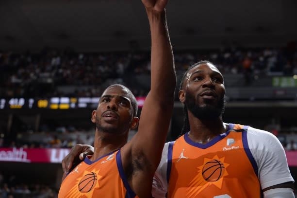 Jae Crowder of the Phoenix Suns puts his arm around teammate Chris Paul during the game against the Denver Nuggets during Round 2, Game 3 of the 2021...