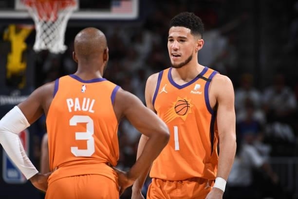 Chris Paul and Devin Booker of the Phoenix Suns talk during Round 2, Game 3 of the 2021 NBA Playoffs on June 11, 2021 at the Ball Arena in Denver,...