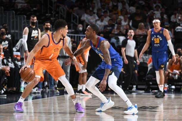 Will Barton of the Denver Nuggets plays defense Devin Booker of the Phoenix Suns during Round 2, Game 3 of the 2021 NBA Playoffs on June 11, 2021 at...