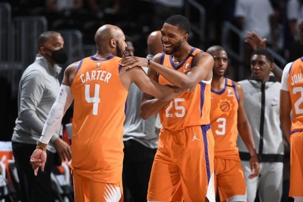 Mikal Bridges and Jevon Carter of the Phoenix Suns embrace after the game against the Denver Nuggets during Round 2, Game 3 of the 2021 NBA Playoffs...