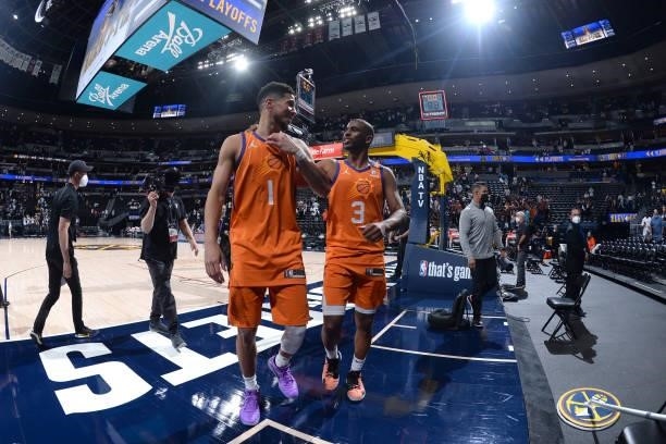 Devin Booker and Chris Paul of the Phoenix Suns walk off the court after the game against the Denver Nuggets during Round 2, Game 3 of the 2021 NBA...