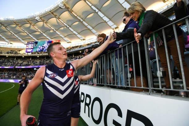 Josh Treacy of the Dockers celebrates with the fans during the 2021 AFL Round 13 match between the Fremantle Dockers and the Gold Coast Suns at Optus...